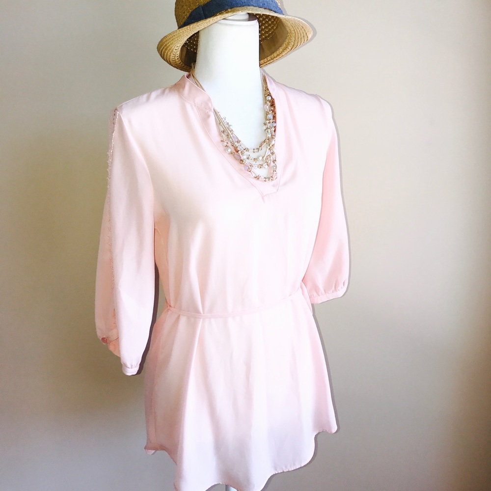 Soft, light pink blouse with side tie.